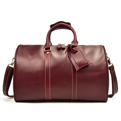 Bolso CHICAGO de viaje de piel color rojo vino con correa para el hombro.
