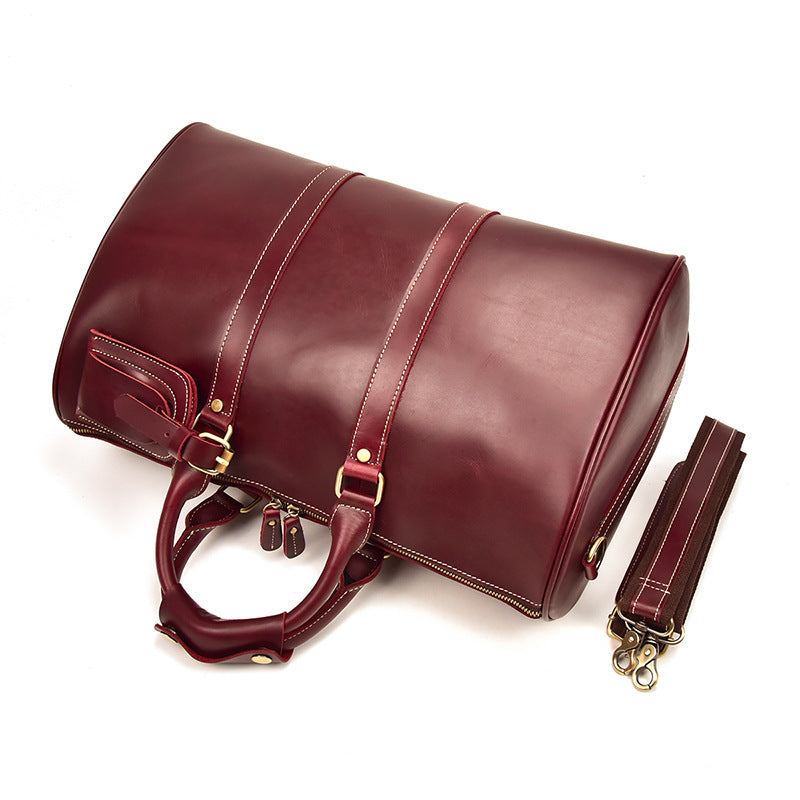 Bolso CHICAGO de viaje de piel color rojo vino con correa para el hombro.