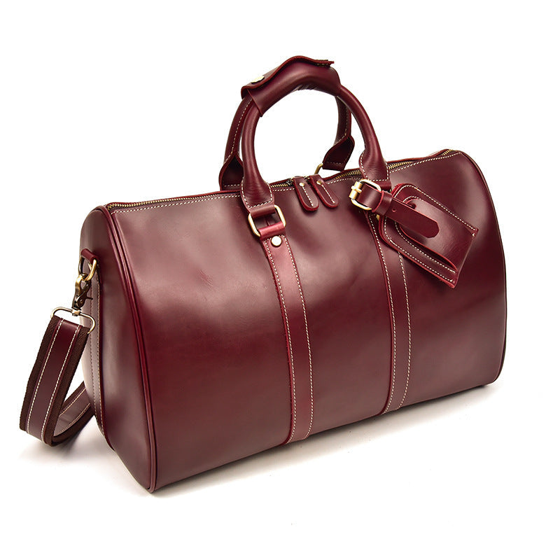 Bolso CHICAGO de viaje de piel color rojo vino con correa para el hombro.