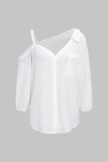Camisa CASANDRA asimétrica de manga larga sin espalda con botones.