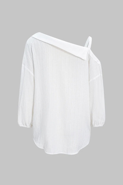 Camisa CASANDRA asimétrica de manga larga sin espalda con botones.